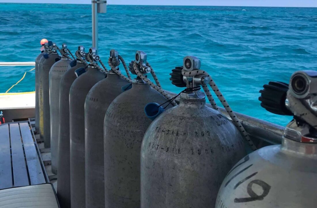 Reduced-tanks-on-boat-on-reef-scaled-e1610918253697